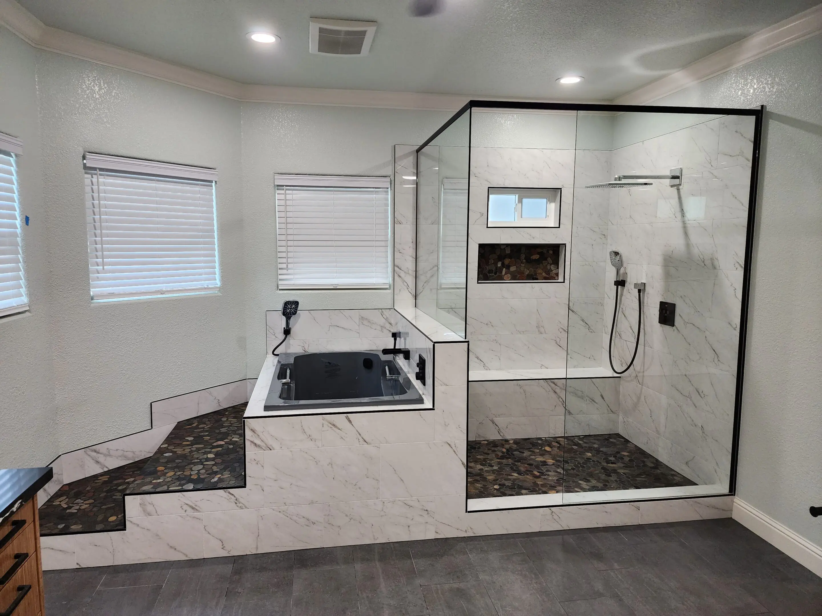 A bathroom with a tub and shower in it
