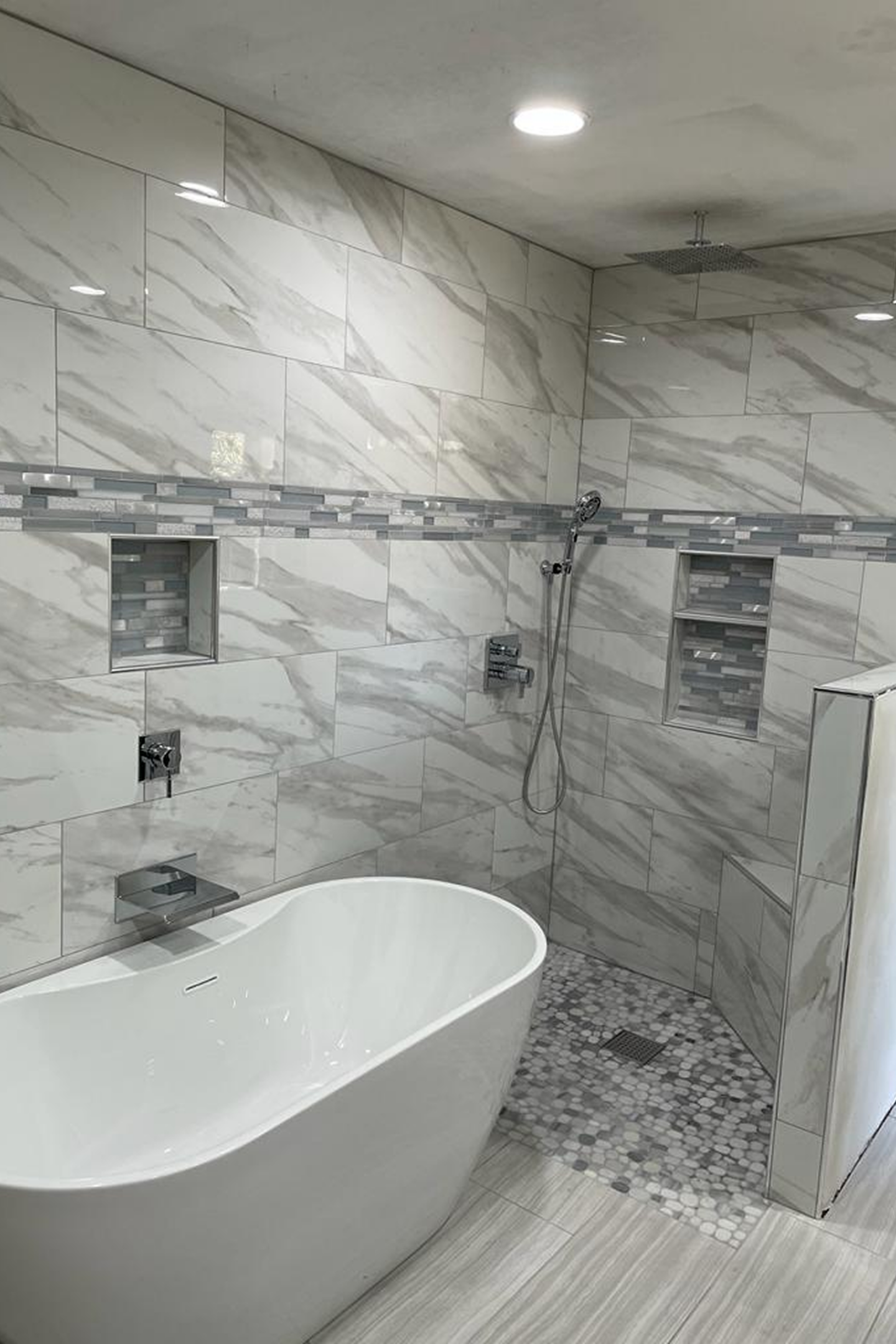 A bathroom with a tub and shower in it