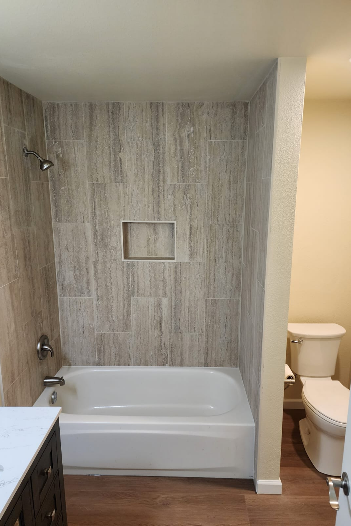 A bathroom with a tub, toilet and sink.