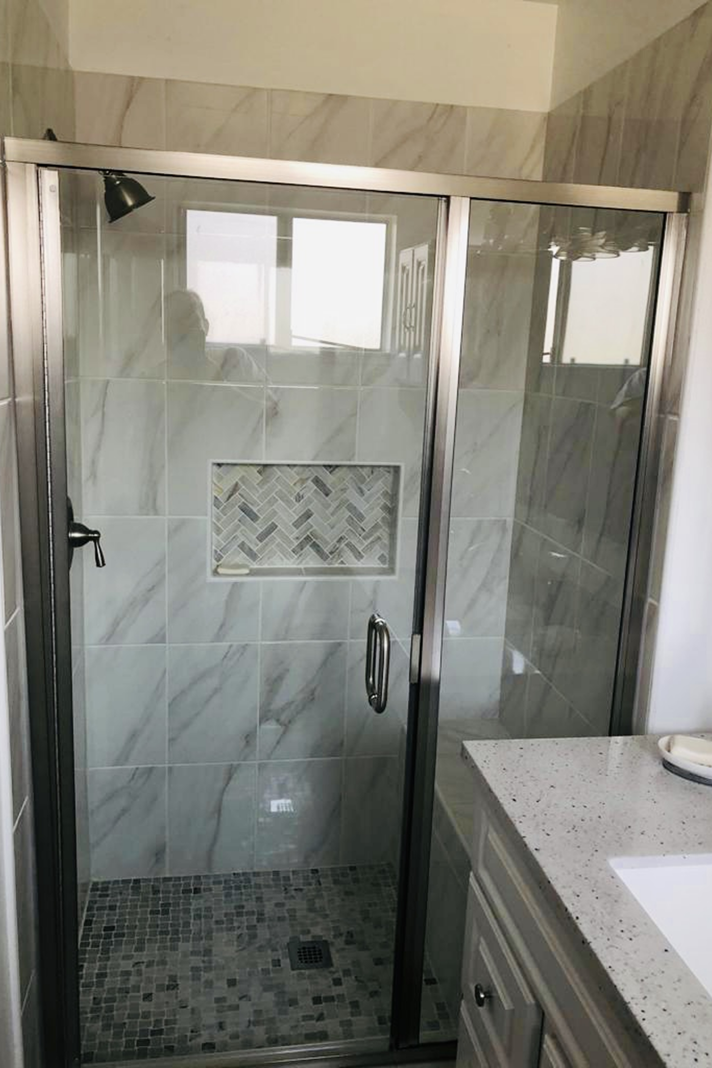 A bathroom with marble walls and floors