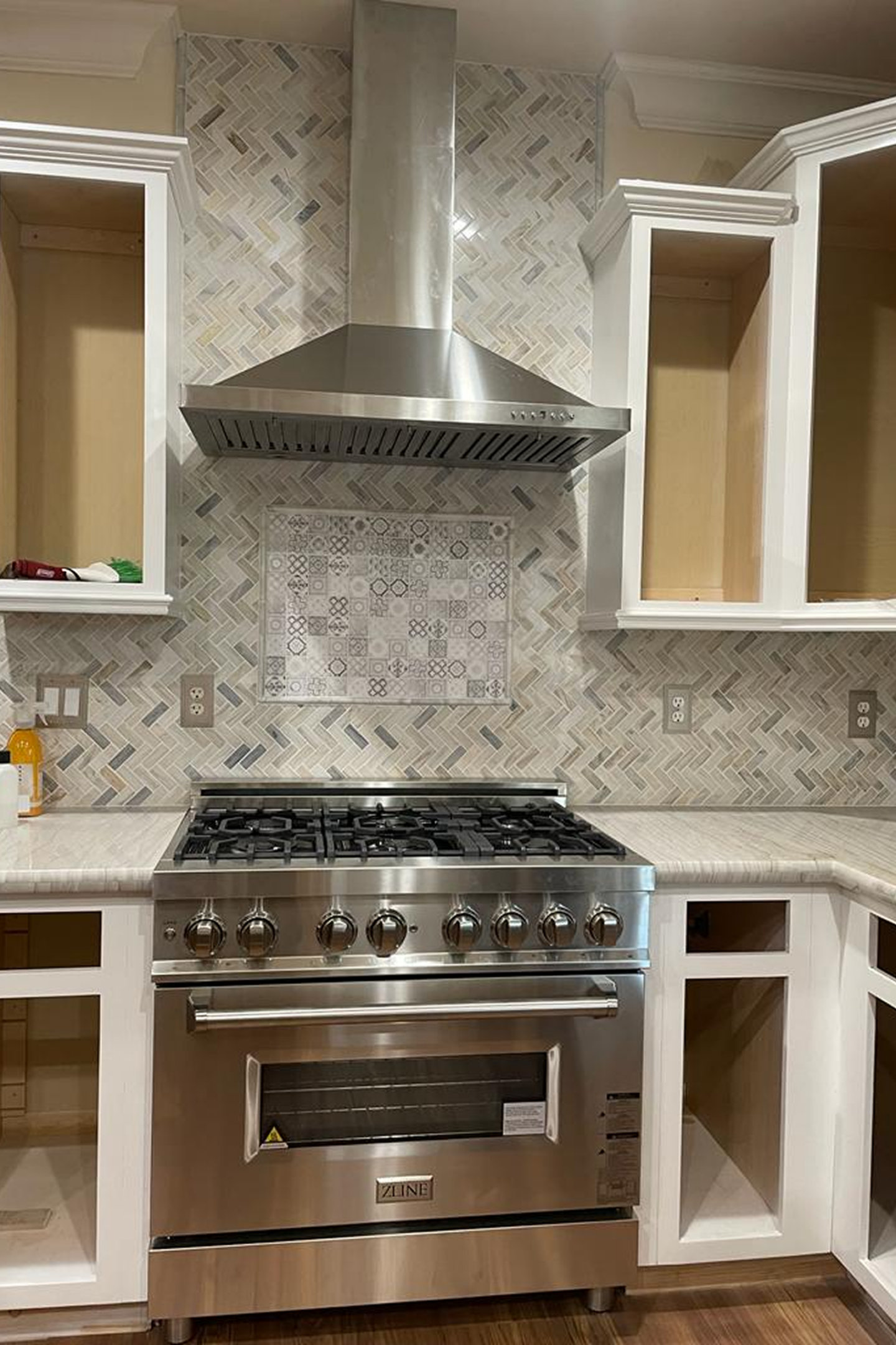 A kitchen with a stove and cabinets in it