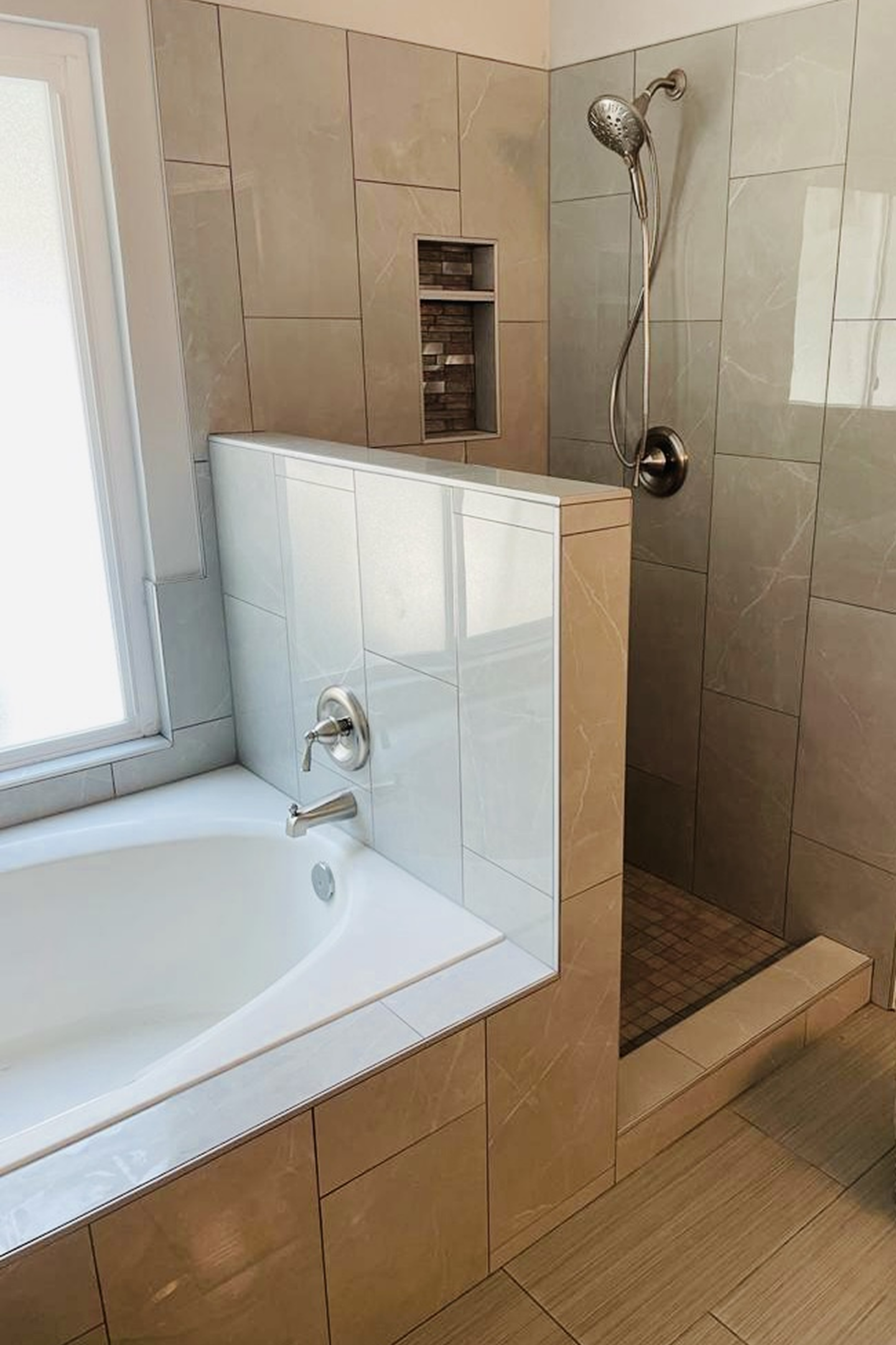 A bathroom with a tub and shower in it