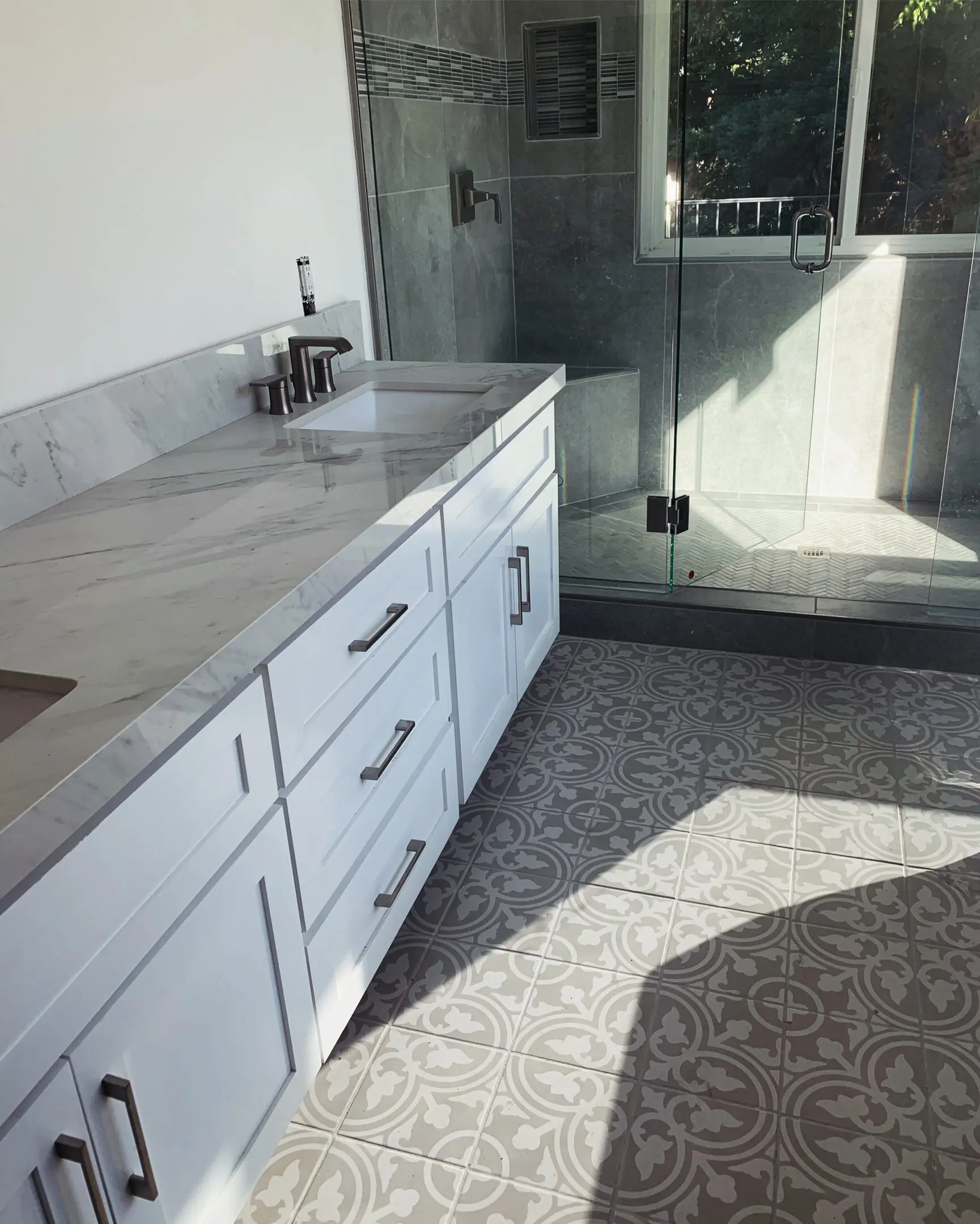 A bathroom with a shower and sink in it