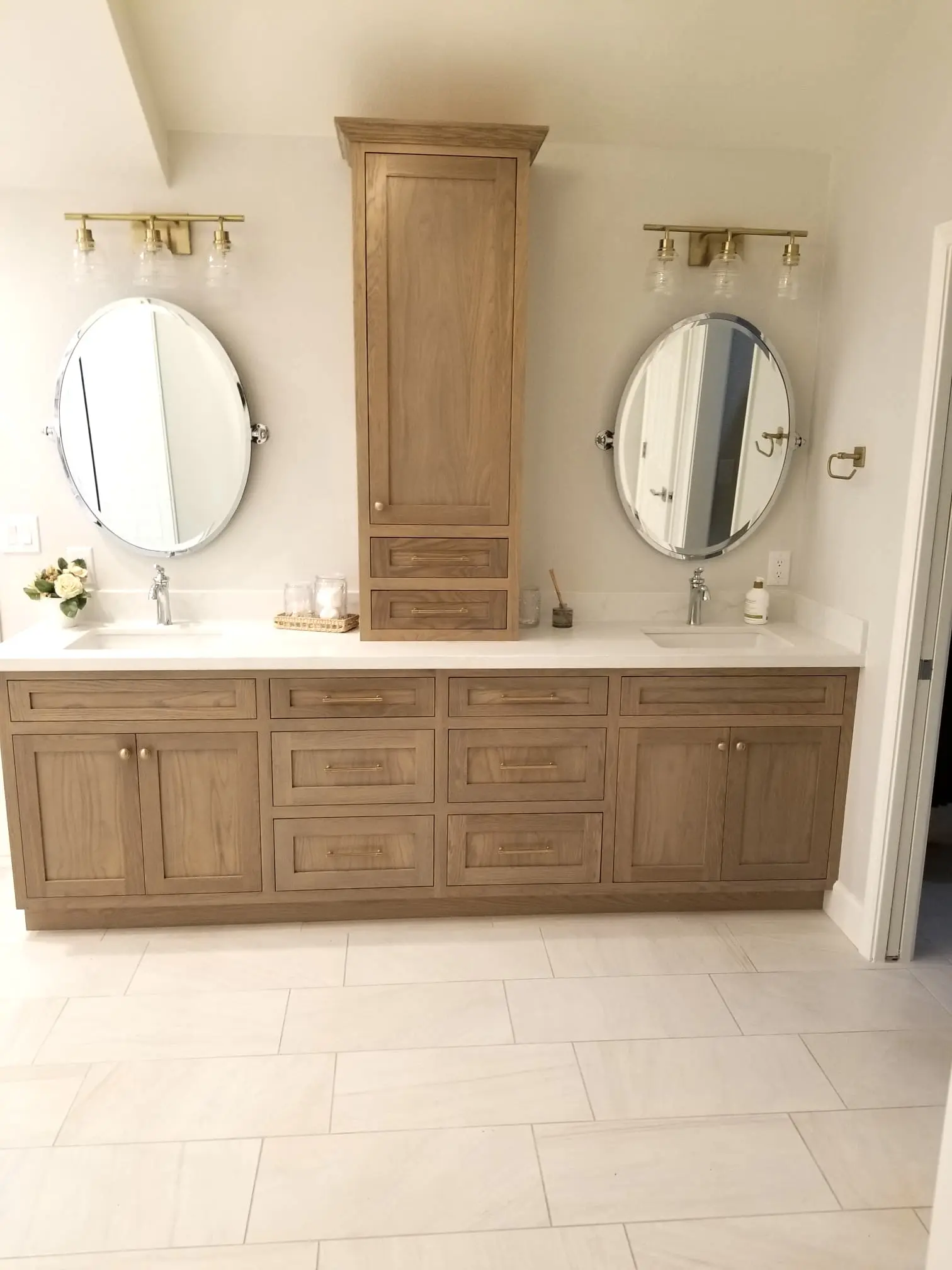 A bathroom with two mirrors and a double sink.